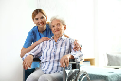 nurse assisting a senior woman
