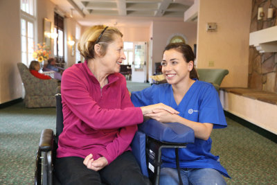 caregiver and a senior woman in a wheelchair