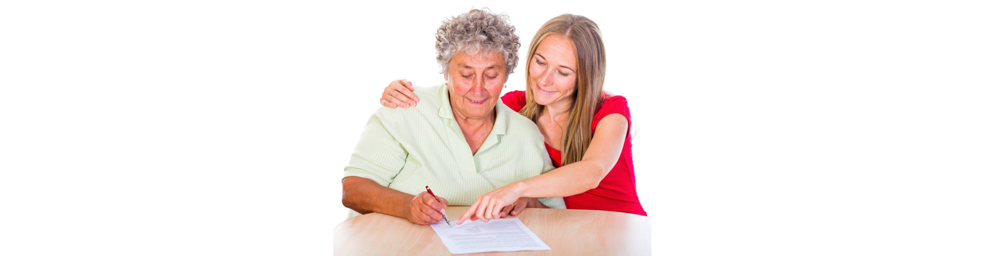 a caregiver assisting senior woman filling a form