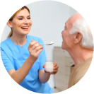 caregiver giving meal to the patient