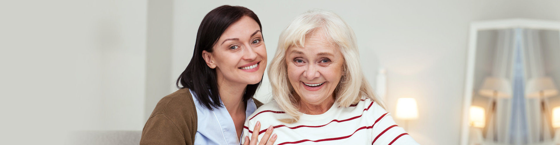 a happy caregiver and a senior woman